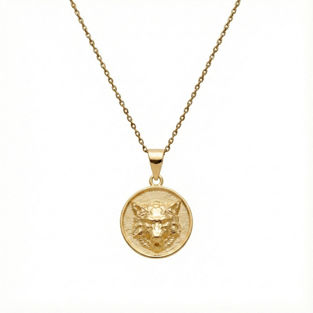 Howling Wolf Medallion sterling silver necklace flat lay on neutral surface