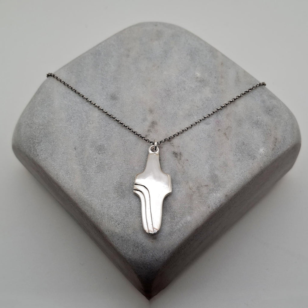Abstract Cross Pendant, close up detail of the fluid cross design