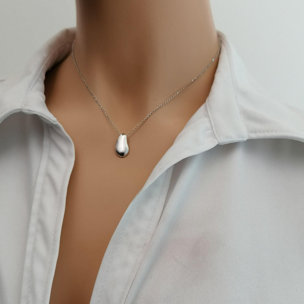 Solid Gold Pebble Necklace | Dainty Organic Fluid Charm | Minimalist River Stone Pendant, close-up detail