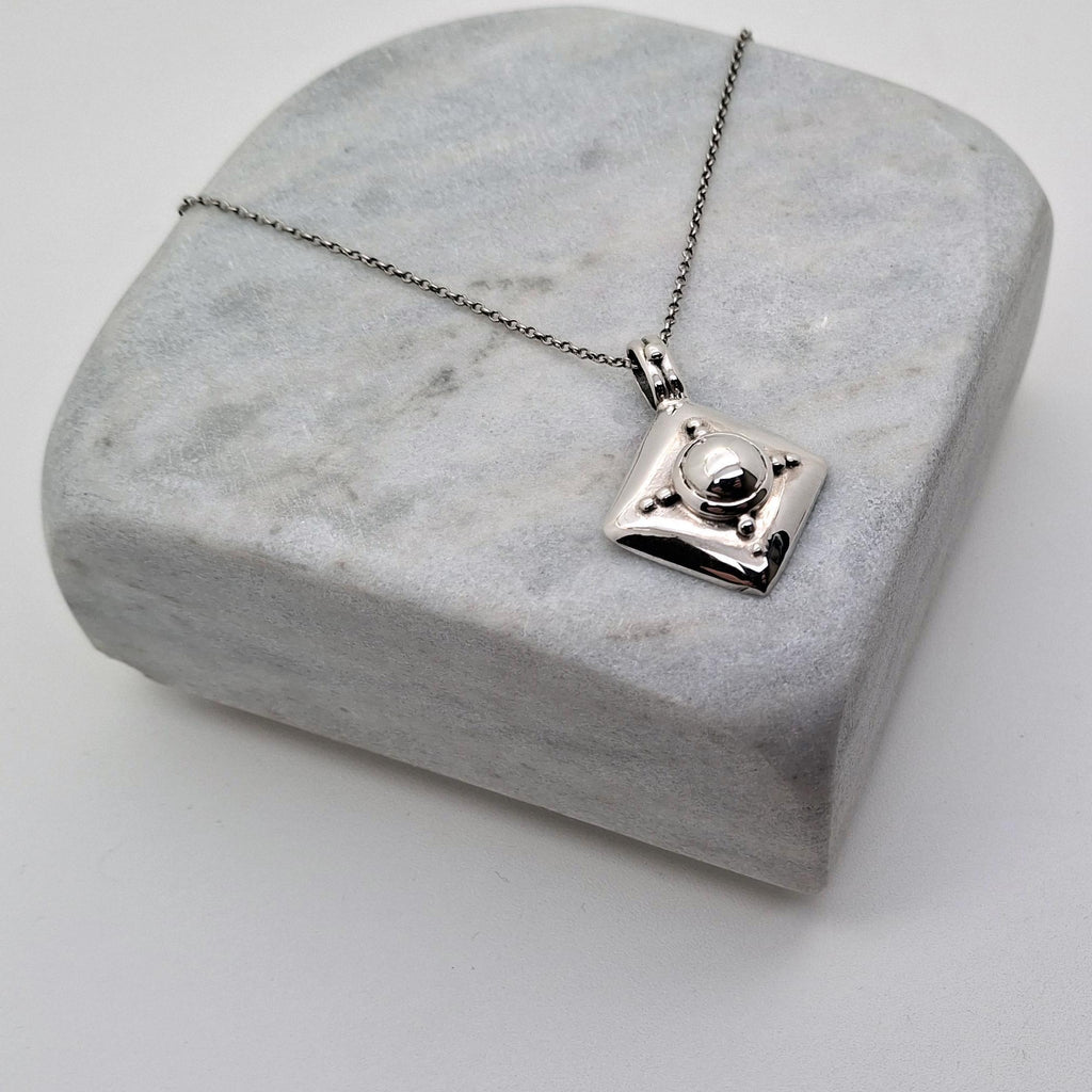 Armor Shield Necklace | Geometric Protection Pendant, close-up detail