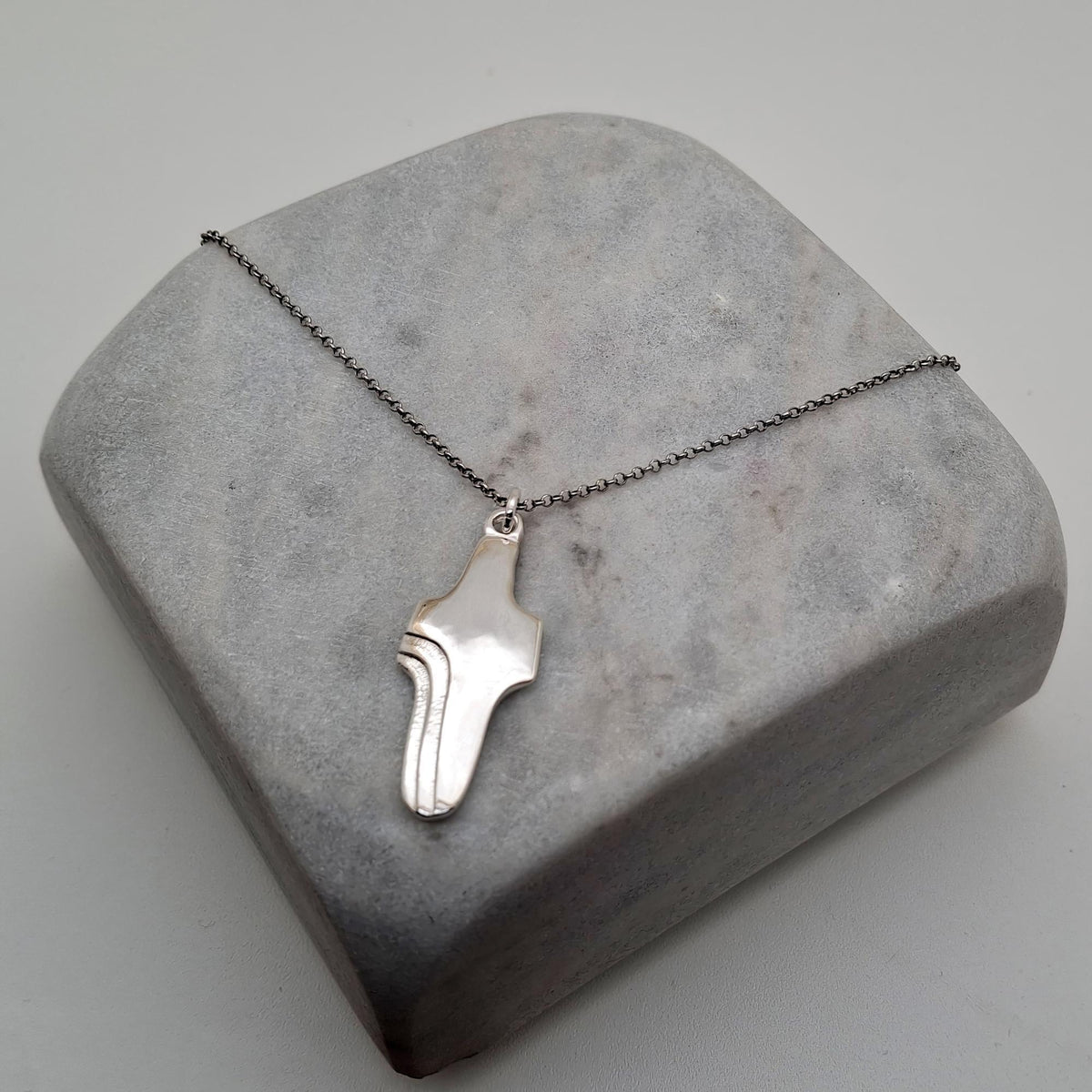 Abstract Cross Pendant, styled on a chain