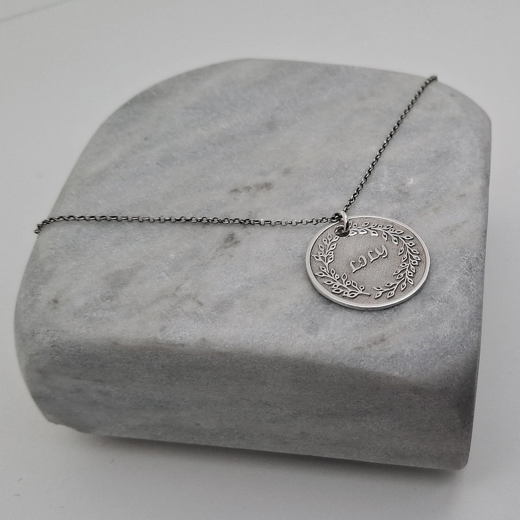 Custom Name Necklace Pendant | Hand-Stamped Sterling Silver Laurel Wreath Charm | Personal Victory Medallion, close-up detail