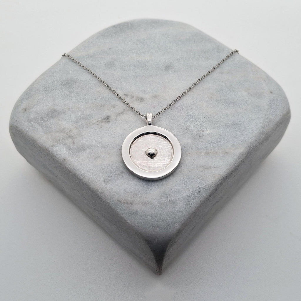 Circumpunct Necklace | Sterling Silver Sacred Geometry Pendant | Minimalist Monad Talisman, styled view