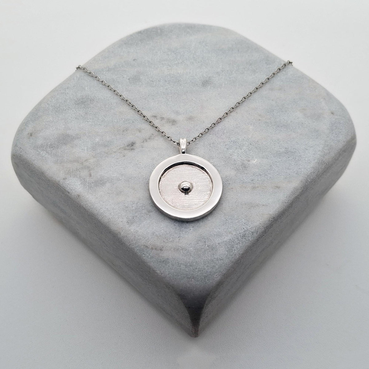 Circumpunct Necklace | Sterling Silver Sacred Geometry Pendant | Minimalist Monad Talisman, styled view